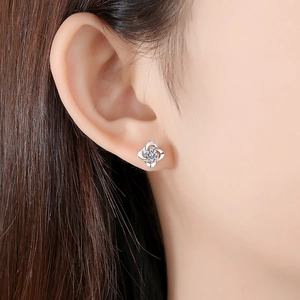 Elegant S999 sterling silver four-leaf clover stud earrings with sparkling center zircon