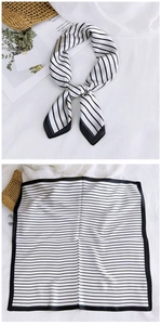 Detail of square silk scarf with black and white stripes and elegant bow styling