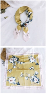 Macro detail of silk square scarf featuring magnolia flowers and a pink stitched border