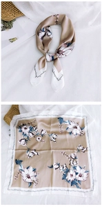Detail of silk scarf with champagne magnolia floral print and calligraphy patterns