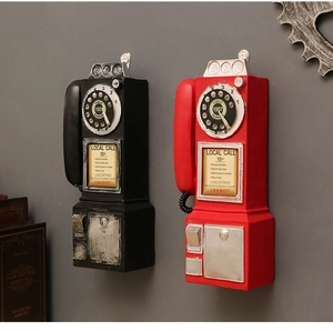 Close-up of retro black and red wall-mounted telephone models with vintage resin texture