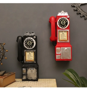 Detail of red and black vintage Crosley telephone resin models in retro home setting