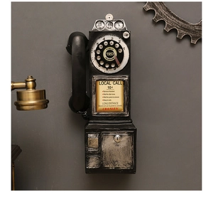 Detail of vintage wall-mounted telephone resin craft with industrial gear wall decor