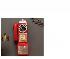 Detail of red vintage resin telephone wall decor with 1957 retro rotary dial design