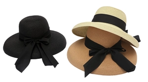 Three colors of straw sun hats with black satin bows in black, beige, and tan