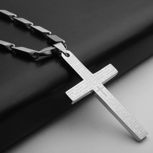 Detail of cross pendant with engraved Spanish Lord's Prayer on a cylinder link chain
