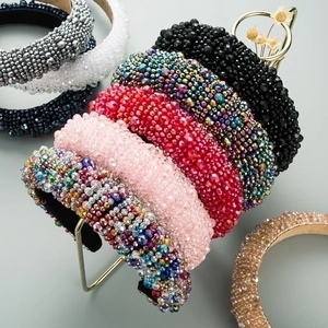 Detailed close-up of wide velvet headbands with intricate colorful bead embellishments