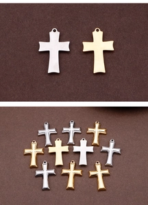 Detailed view of religious stainless steel cross pendants in gold and silver finishes