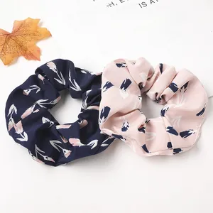 Detail of floral scrunchies with elegant tulip patterns in navy blue and pink chiffon