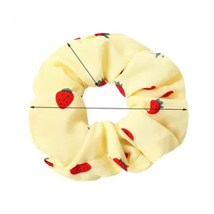 Detail of yellow strawberry print scrunchie showing 12cm outer diameter dimensions