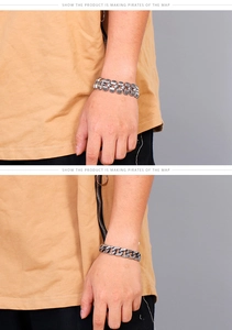 Close-up of men's chunky silver skull bracelet with pirate relief on a wrist
