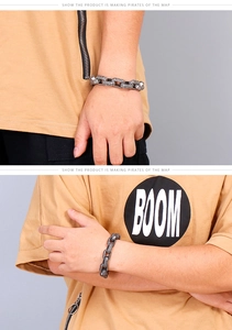 Macro shot of punk style stainless steel chain bracelet with intricate vintage patterns