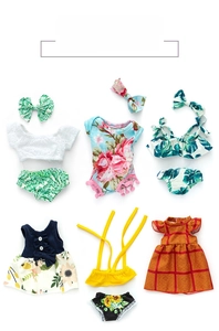 Flat lay view of colorful doll clothing sets including floral dresses and bow headbands