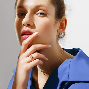 Detail showing double T-shaped rings with sparkling zircons and matching necklaces