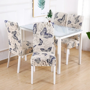 Detail of vintage butterfly print stretch chair cover on dining chairs around table