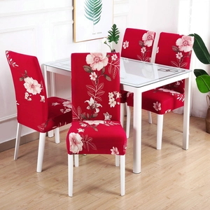 Detail of red floral elastic chair cover with pink flower pattern fitting a dining chair