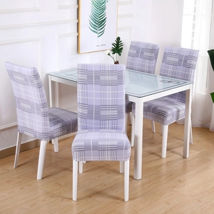 Detail of four light purple plaid stretch chair covers on modern dining chairs