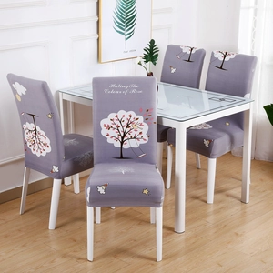 Close-up of purple stretch chair cover with cartoon trees and stars on a dining chair
