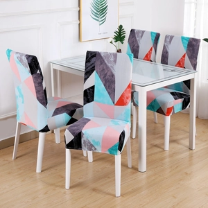 Modern geometric pattern stretch chair covers on dining chairs in a bright room
