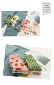 Detail of colorful cotton crew socks featuring cute fruit prints like avocado and peach