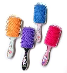 Detailed view of four colorful cartoon air cushion hairbrushes with nylon bristles