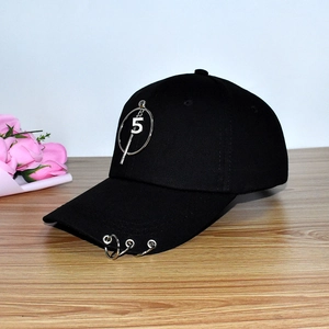 Detail of black cotton baseball cap with silver metal rings on brim and number 5 charm