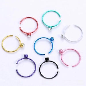 Detail of colorful stainless steel nose rings with sparkling rhinestones in 8 vibrant colors