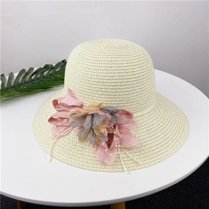 Creamy white straw sun hat for women featuring a large decorative floral side detail