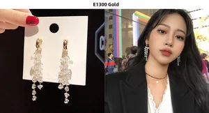 Detail of long gold tassel earrings with clear crystal stones and white pearls on a model