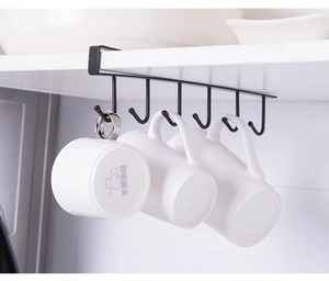Detail of a black metal under-cabinet rack with 6 hooks holding ceramic mugs