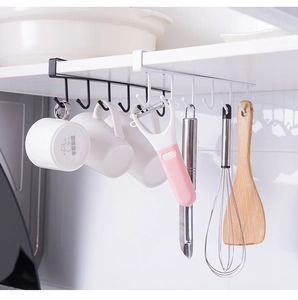 Detail of under-cabinet 6-hook iron rack holding kitchen tools and mugs in black and white