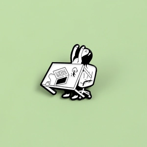 Cartoon enamel pin of a character at a desk with laptop on a light green background