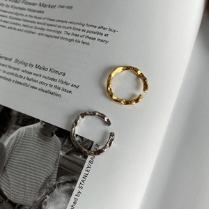 Macro detail of wave texture on S925 sterling silver adjustable open rings in gold and silver