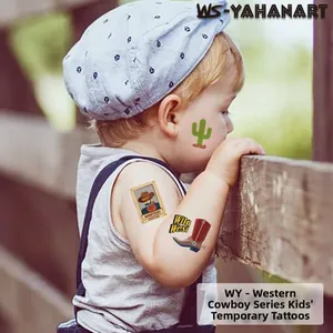 Close-up of children's cowboy tattoos with green cactus and red boots on a child's arm