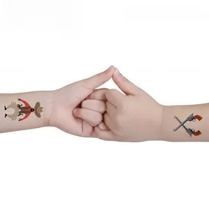 Close-up of children's western cowboy temporary tattoos with sheriff star and pistols