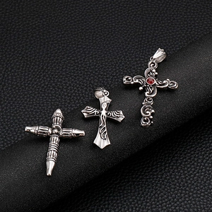 Vintage gothic stainless steel cross pendants with red gemstone detail on black background