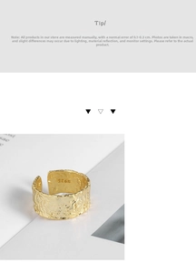 Macro detail of the S925 hallmark engraving on golden irregular hammered surface ring