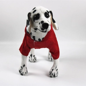 Close-up of red waterproof hooded dog raincoat with white trim on dalmatian model