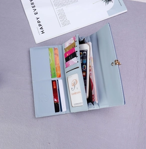 Detail view of light blue leather wallet interior with 10 card slots and phone compartment
