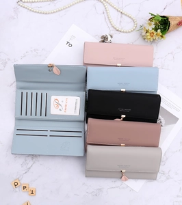 Flat lay of multi-color long wallets for women with multi-card slots and leaf pendant