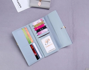 Detailed view of light blue leather long wallet featuring multiple card slots and photo window