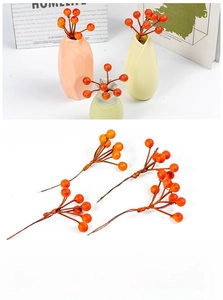 Artificial red berry stems in a geometric vase for home and living room decoration