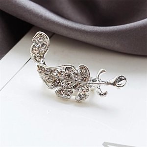 Sparkling leaf brooch with embedded crystals in a polished silver-tone metal finish