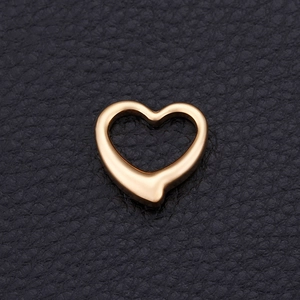 Polished golden stainless steel open heart pendant on a premium black leather background