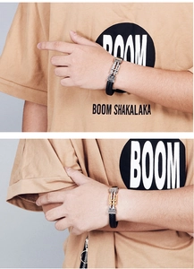 Close-up of men's braided leather bracelets with silver and gold magnetic metal clasps