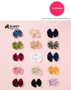 Flat lay of 15-piece velvet bow hair clips set for kids in various soft colors