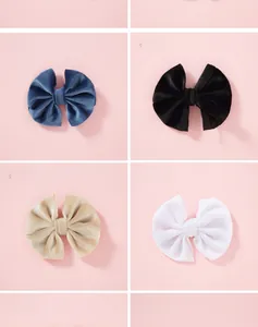 Detail view of velvet bow hair clips in navy, black, champagne and white colors