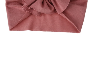 Detailed close-up of soft knitted cotton baby turban hat in dusty rose pink color