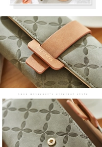 Detailed macro shot of grey-green floral embossed texture and metallic magnetic clasp