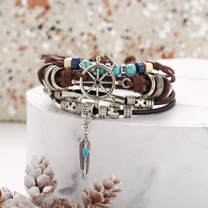 Multilayer leather wrap bracelet with turquoise beads and silver feather and helm charms